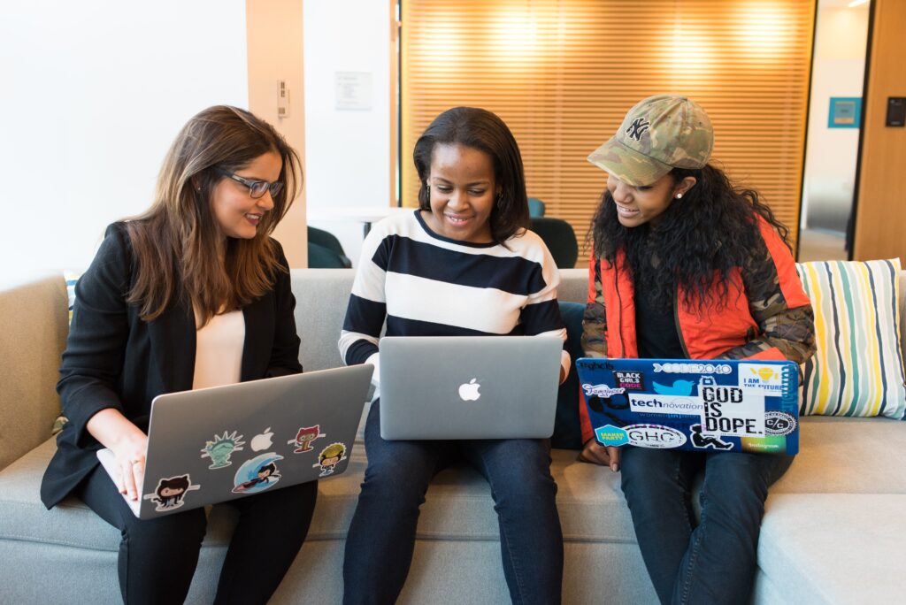 Three women looking at their laptops