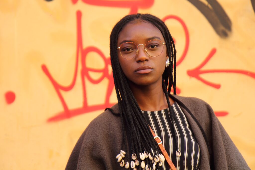 A woman with glasses staring into the camera