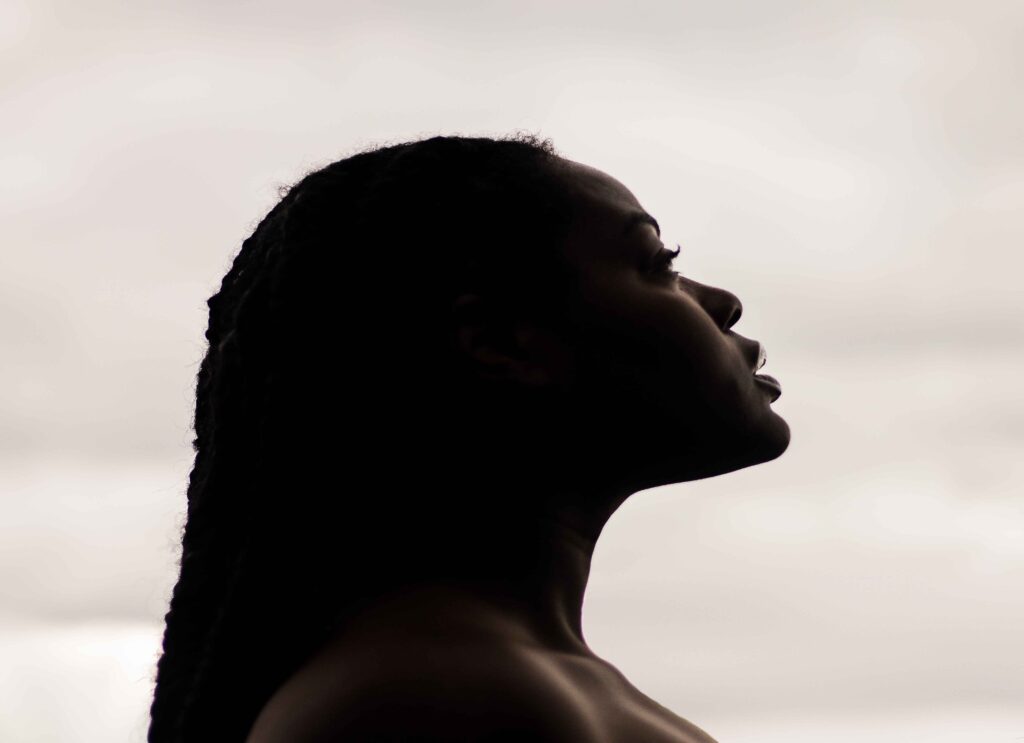 A Black woman looking into the distance.